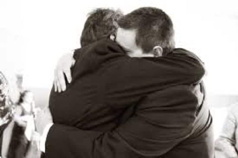 a man hug his lover in police station