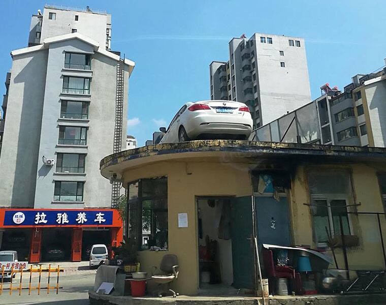 Driver leaves car parked in middle of bus station returns to find it on roof of a building