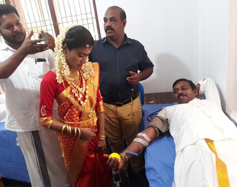 new married couple donate blood in their wedding