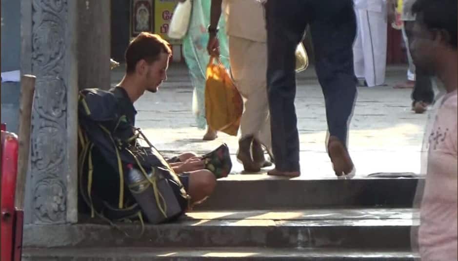 Russian tourist resorts to begging outside Tamil Nadu temple