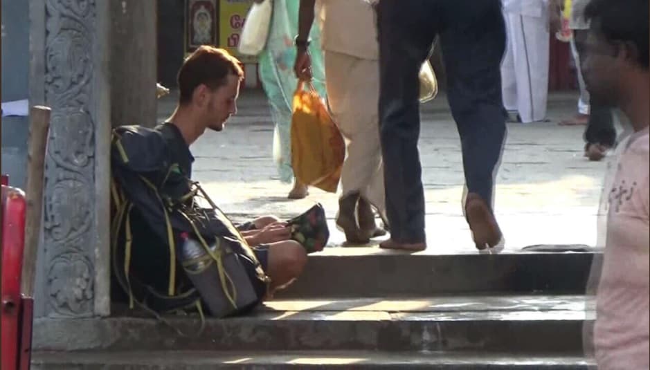 Russian tourist resorts to begging outside Tamil Nadu temple