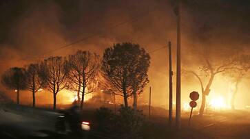 Twin wildfires burn 7 California homes, threaten 10,000 more