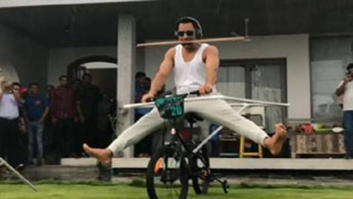 Mahendra Singh Dhoni doing funny bicycle stunt Mahendra Singh Dhoni doing funny bicycle stunt