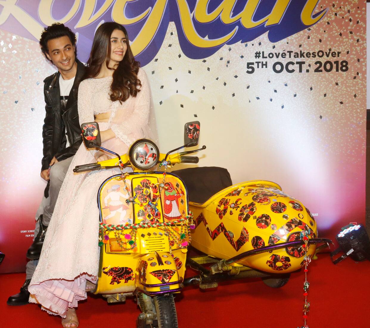 Aayush and Warina posed with a scooter which is one of the main props of their film.