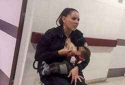 IN ARGENTINA POLICE OFFICER FEED MILK TO HUNGRY CHILD