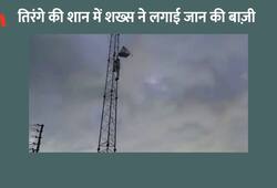 man climbed to the mobile tower on the mountain to honor the Tricolor