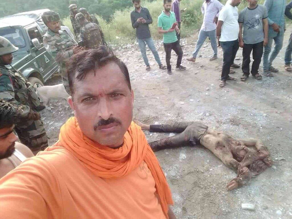 The man clicking selfie with a militants body which was dragged