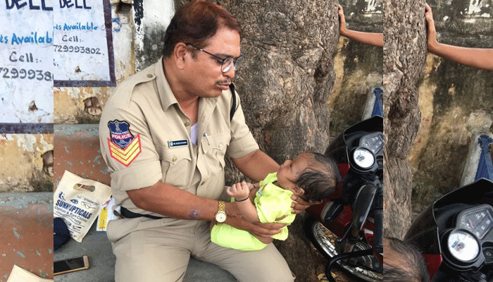 Police Constable Trying to console a crying baby Police Constable Trying to console a crying baby