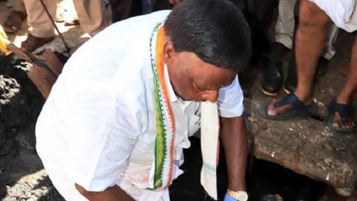 Puducherry Chief Minister V Narayanasamy steps inside a drain and clean Puducherry Chief Minister V Narayanasamy steps inside a drain and clean