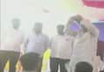 Karnataka Revenue Minister RV Deshpande throws sports kits from a stage to athletes Karwar