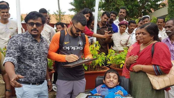Virat Kohli MS Dhoni meet a special fan in Thiruvanathapuram Virat Kohli MS Dhoni meet a special fan in Thiruvanathapuram