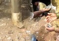 Coins flow out like fountain while installing bore; villagers amused