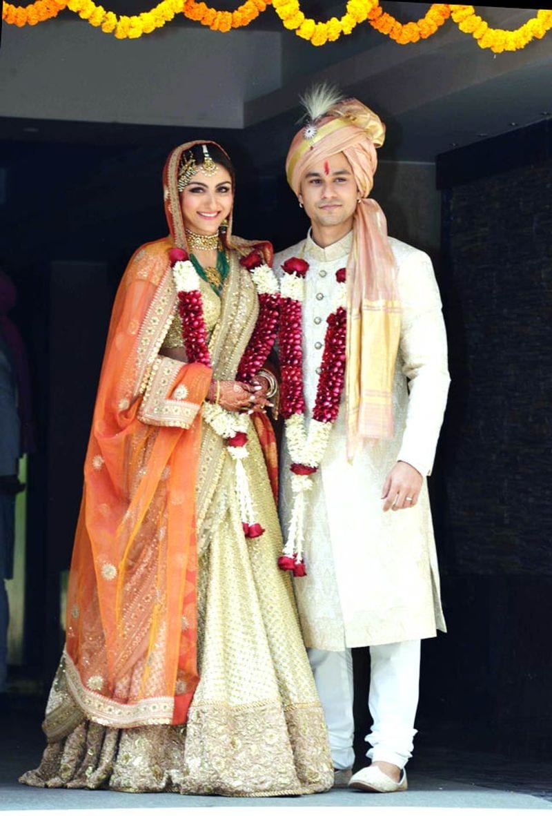 To exchange vows with husband, actor Kumal Khemu, Soha Ali Khan chose a lehenga from the designer's Opium collection. The orange and gold outfit was paired up with heavy jewellery and a passa.