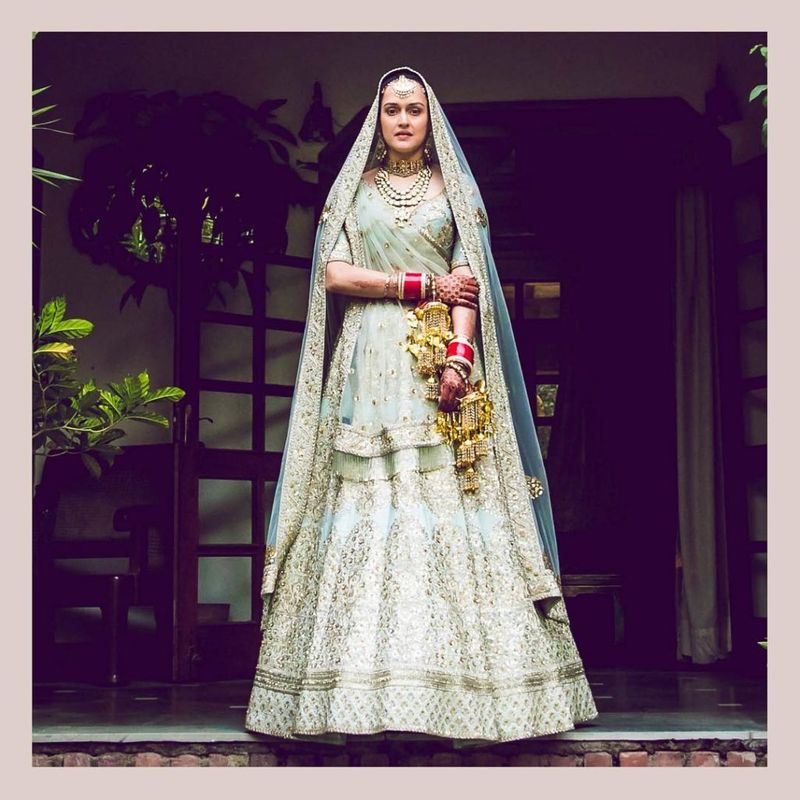 Moving away from the usual bridal red, Pia chose a design from Sabyasachi’s Devi collection. The duck egg blue lehenga in Indo-Victorian pattern with fine aari-taari and zardozi and minimal make-up made her really stand out.