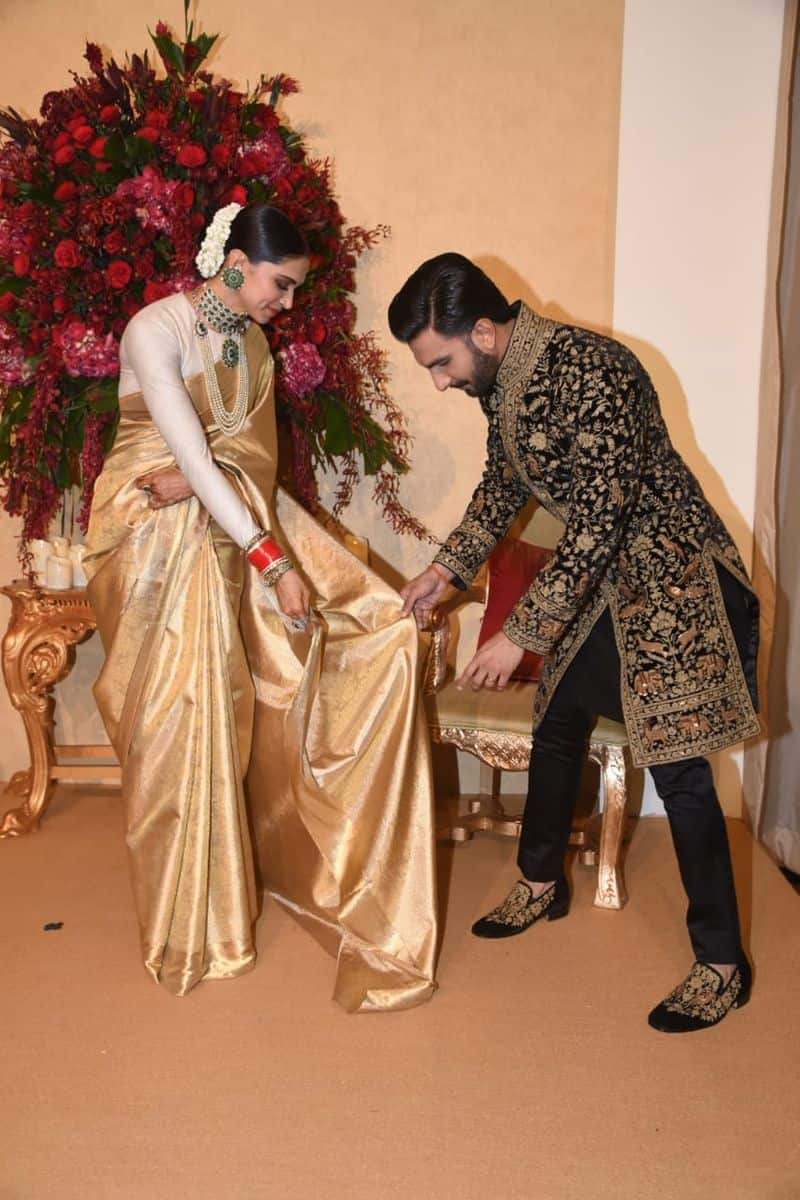 Deepika Padukone chose a gold saree gifted by her mother Ujjala Padukone for the occasion. The actress accessorised her look with a heavy emerald choker and matching earrings. Ranveer Singh, on the other hand, looked dapper in a heavily embroidered black and gold kurta by Rohit Bal.