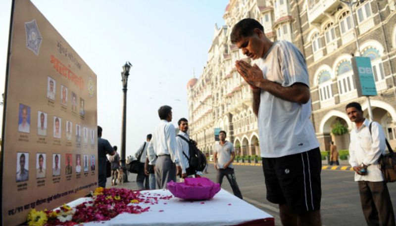 A man pays homage to those who had died in the 2611 terror attacks at a memorial outside the Taj Mahal Palace hotel.