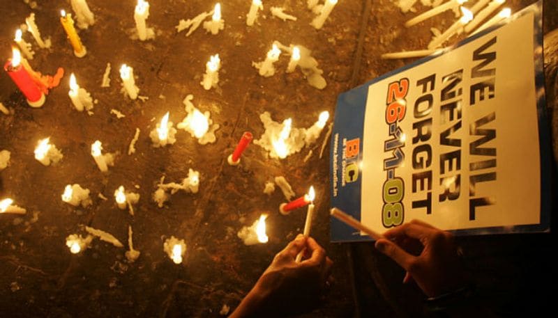 People light candles outside the Taj hotel as a tribute to the victims of the 2611 attacks.