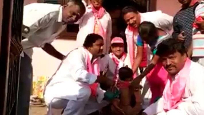 TRS man washes baby s bum to campaign for votes TRS man washes baby s bum to campaign for votes