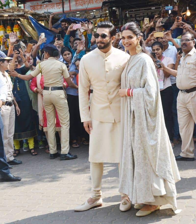 The newlyweds continued the trend of colour-coordinated wedding outfits and wore matching cream and gold ensembles.