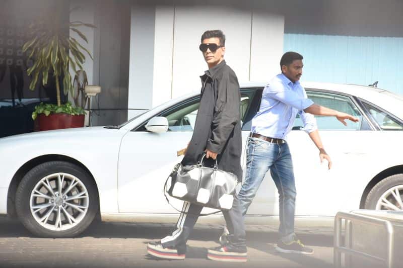 Karan Johar rocks flatform sneakers and a chic travel bag as he heads to Udaipur.