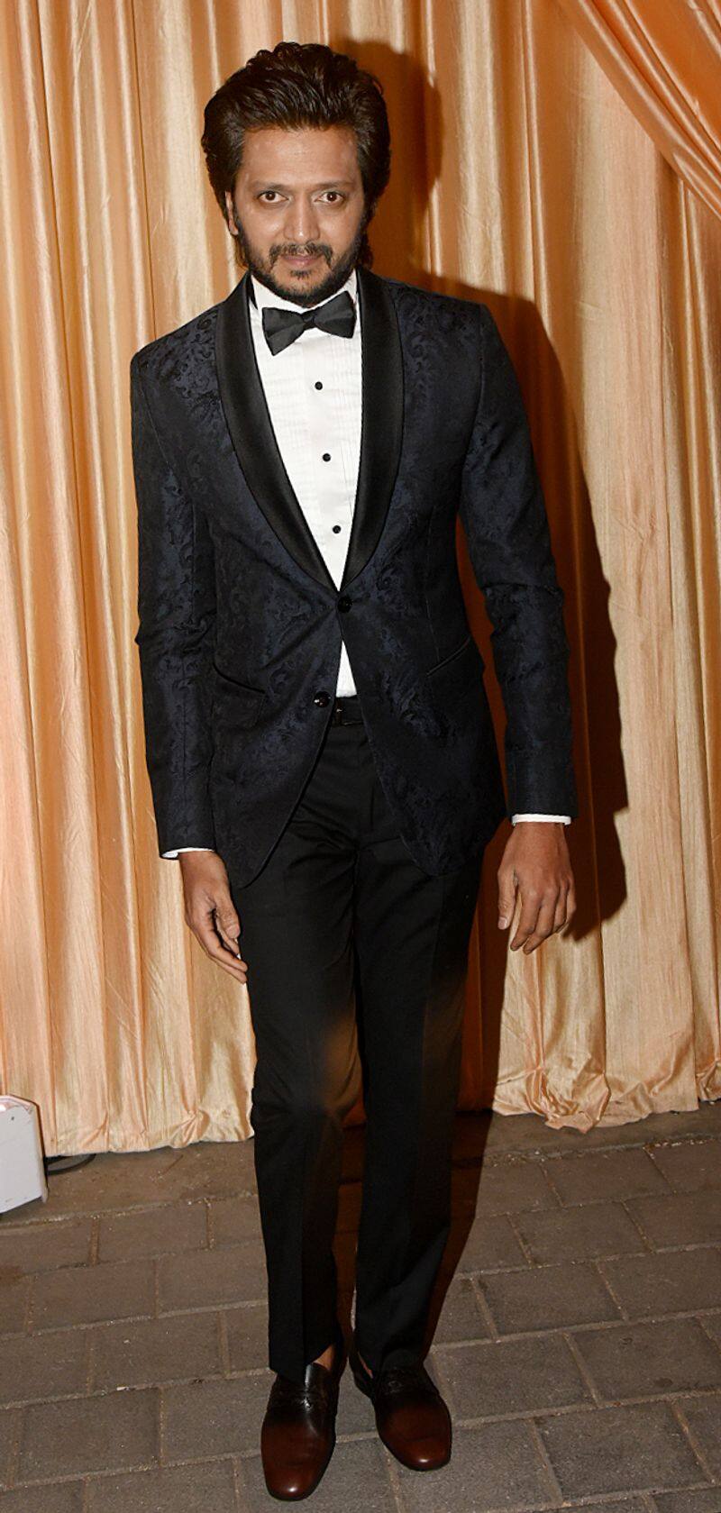 Riteish Deshmukh poses solo for the paps in his tuxedo look.