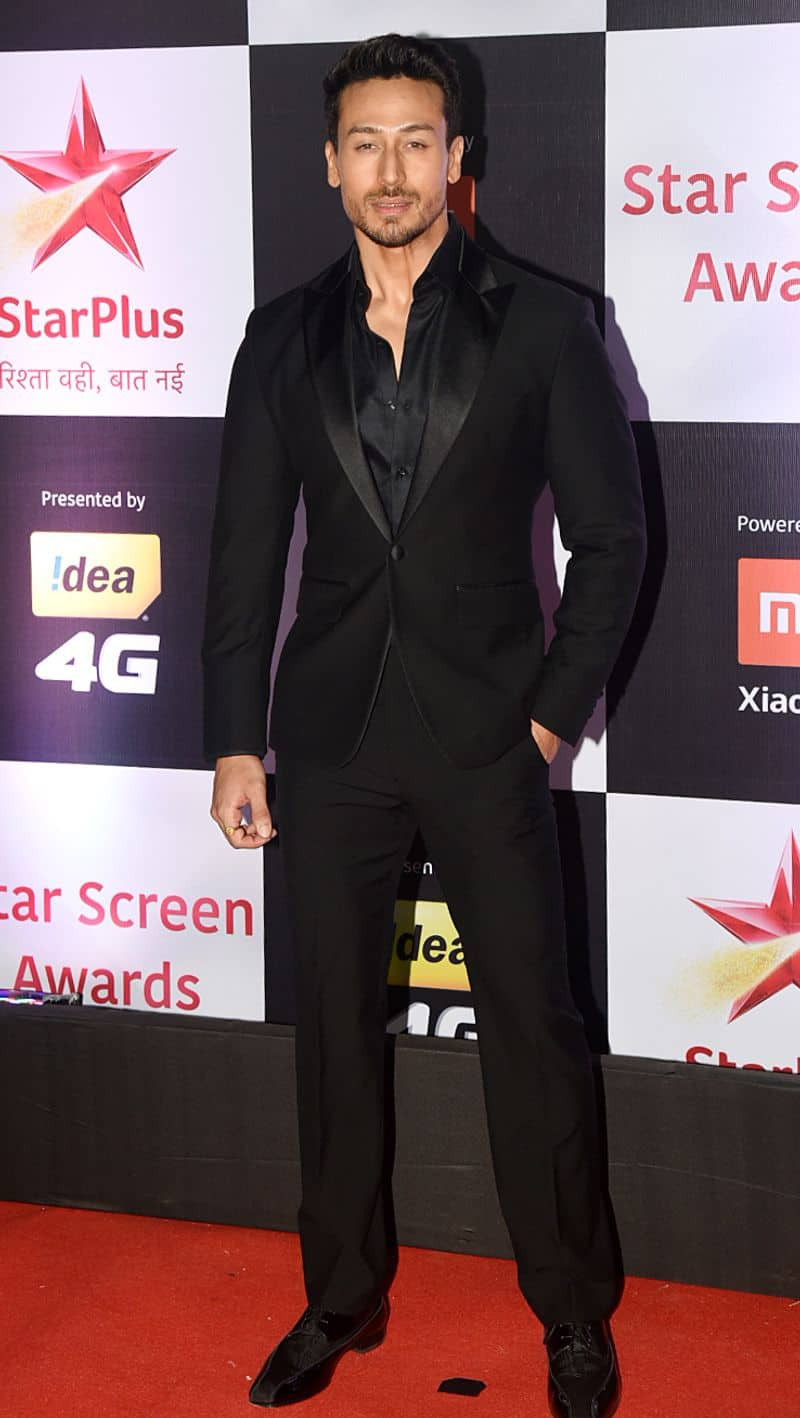 Tiger Shroff opts for a luxe take on the traditional black pantsuit.