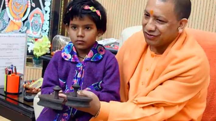 rimjith gifted wooden clogs to yogi adithyanath as her father wish rimjith gifted wooden clogs to yogi adithyanath as her father wish