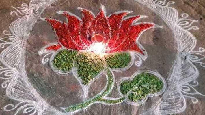 women put lotus kolan in fron of th house women put lotus kolan in fron of th house