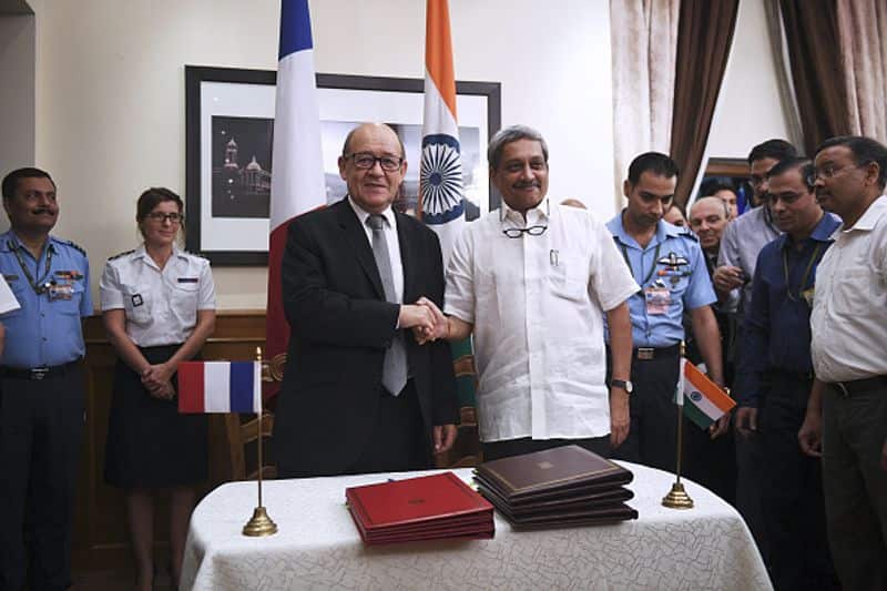 French defence minister Jean Yves le Drian (CL) and Manohar Parrikar (CR) shook hands after signing the deal for India's purchase of 36 French Rafale fighter jets in New Delhi on September 23, 2016