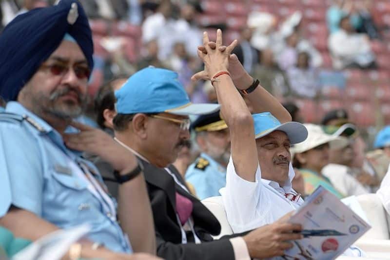 Manohar Parrikar, National Security Advisor Ajit Doval, and Air Chief Marshal of the Indian Airforce Birender Singh Dhanoa watched the Surya Kirans aerobatic team of the Indian Air Force during an aerial display over the skies of Yelahanka Air Force Station on the inaugural day of the 11th edition of 'Aero India', a biennial air show and aviation exhibition, in Bengaluru on February 14, 2017.