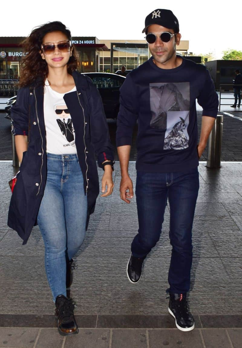 Playing casual while jet-setting, couple Patralekha and Rajkummar Rao, colour-coordinated navy outfits.