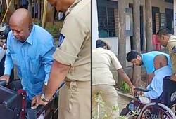 Physically challenged elderly man arrives wheelchair cast vote