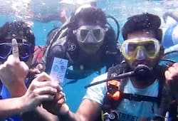 Karwar deputy commissioner distributes voter IDs underwater