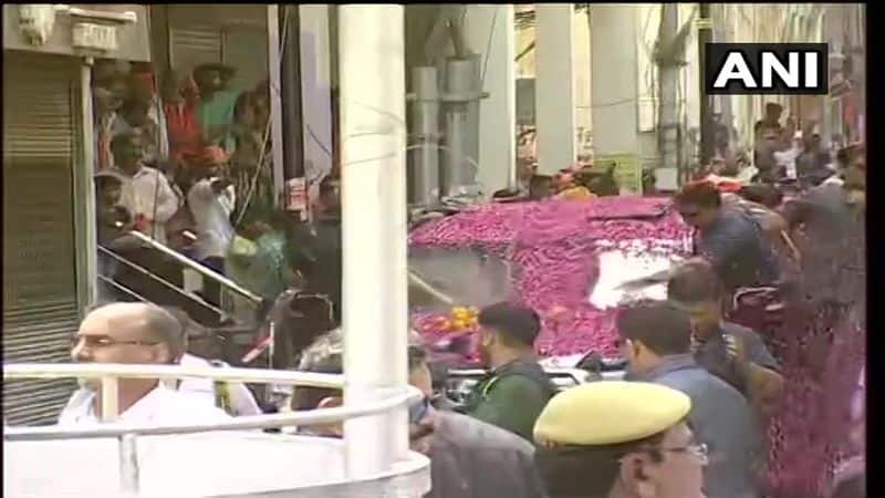 PM Modi's car gets covered with rose petals as party workers showers rose petals before he enters Kal Bhairav temple in Varanasi.