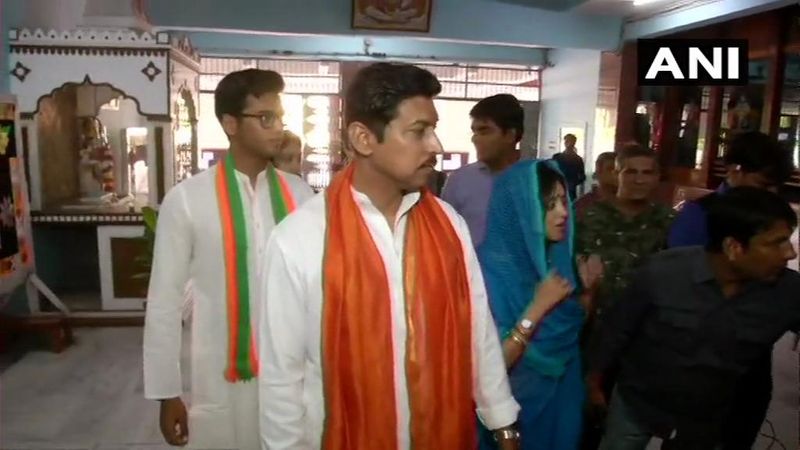 Union Minister Rajyavardhan Singh Rathore and his wife Gayatri Rathore arrive at a polling station in Jaipur to cast their votes.