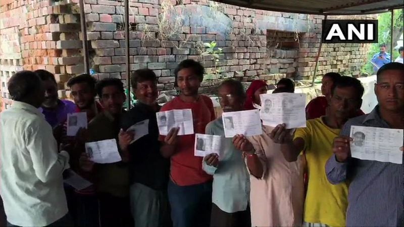 Voters queue up outside a polling station in Ayodhya even before the gates of the polling booth were open.