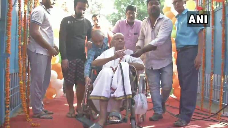 An elderly man on a wheelchair brought to a polling booth in Chhapra, Saran
