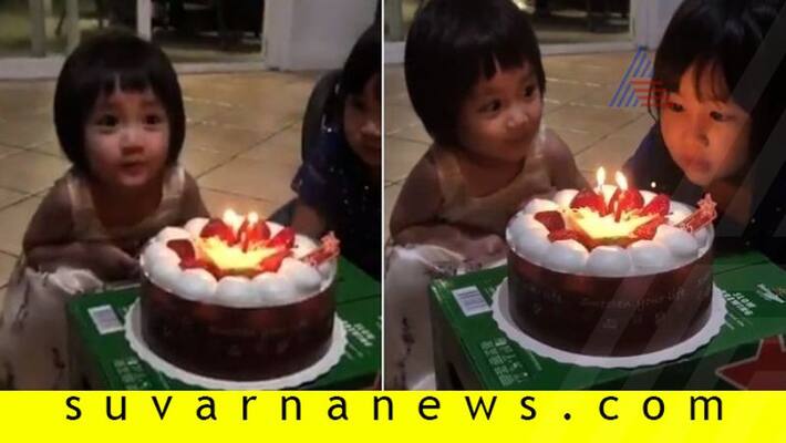 Two year old lets upset sister blow out candles on her birthday cake Two year old lets upset sister blow out candles on her birthday cake