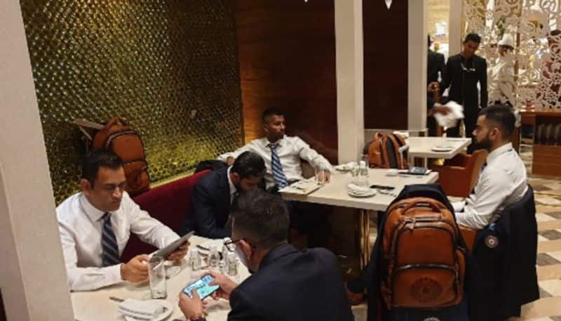 MS Dhoni is busy watching something on his tab while Virat Kohli (far right) is seen with Hardik Pandya.