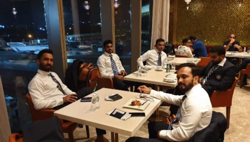 Dinesh Karthik (left) is seen with Kedar Jadhav while at the next table Vijay Shankar is seated with others.