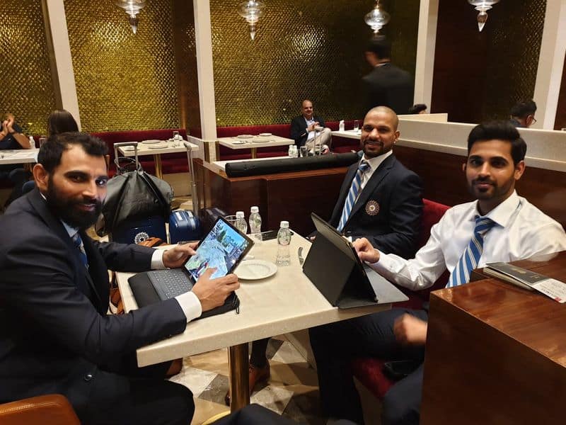 Mohammed Shami, Shikhar Dhawan and Bhuvneshwar Kumar. Shami is seen playing PUBG.