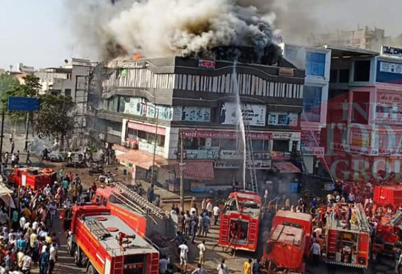 Surat fire Builder manager complex arrested death toll 22
