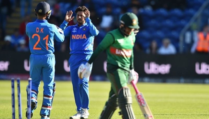 Kuldeep Yadav (centre) celebrates a wicket with Karthik. He accounted for three victims.