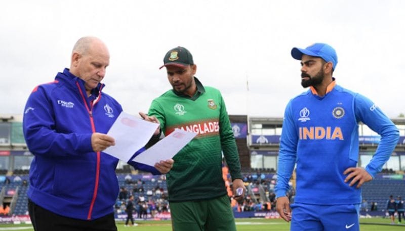 Virat Kohli of India and Bangladesh captain Mashrafe Mortaza exchange team sheets with match referee Andy Pycroft before their ICC World Cup 2019 warm-up match at Cardiff Wales Stadium in Cardiff, Wales. Mortaza won the toss and chose to field first.