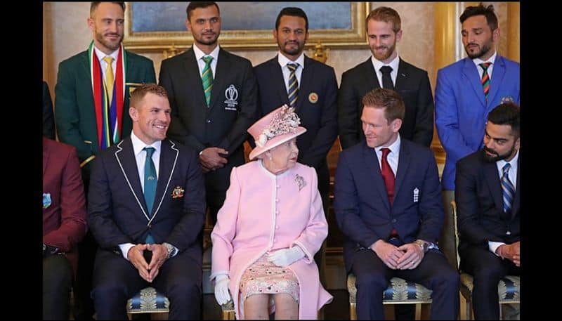 Queen Elizabeth talks to Eoin Morgan and Virat Kohli