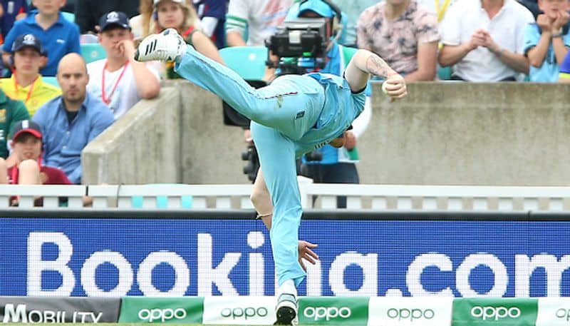 After grabbing the catch with one hand, Ben Stokes loses his balance but manages to hold on to the ball and stay inside the boundary. Stokes's catch sent back Andile Phehlukwayo off Adil Rashid's bowling