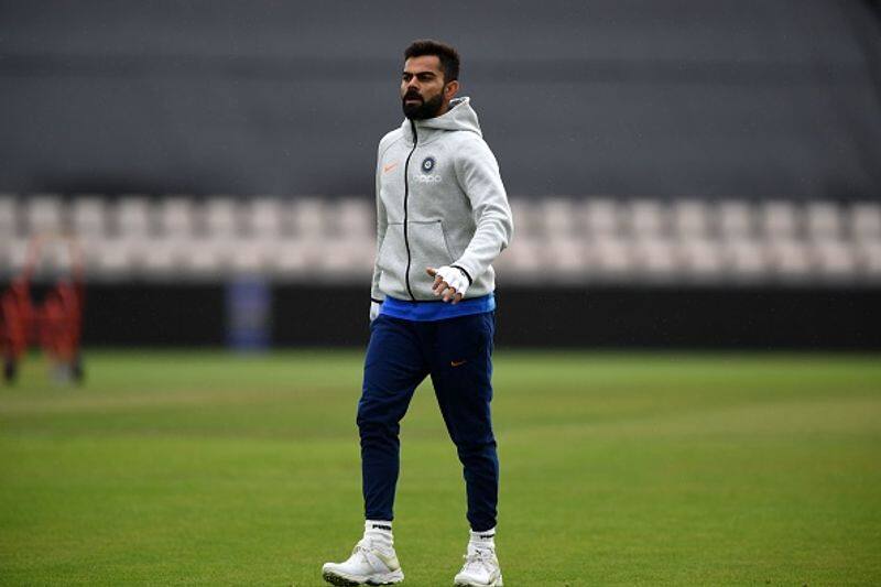 Kohli walks on the ground before taking part in a batting session