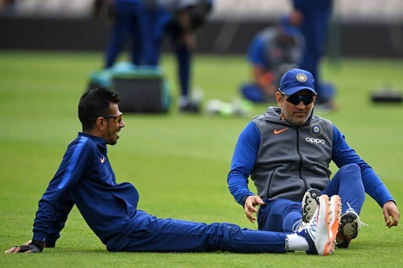 Chahal and Dhoni do some stretching