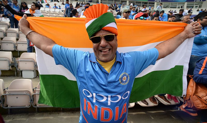 An Indian fan poses with the tri-colour at the stadium