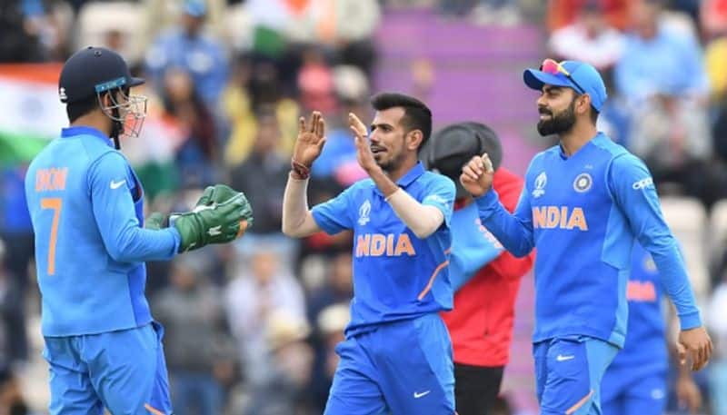 Dhoni, Chahal and Kohli celebrate a wicket